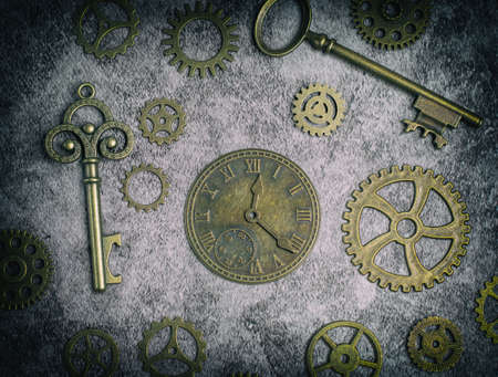 Steampunk style image with a clock, keys, cogs and gears.の写真素材
