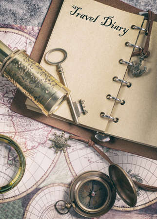 Retro travel with a map, compass, diary and telescopeの写真素材