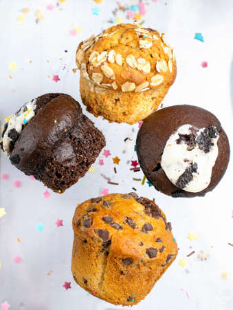 Variety of fresh muffins with colourful sprinklesの写真素材