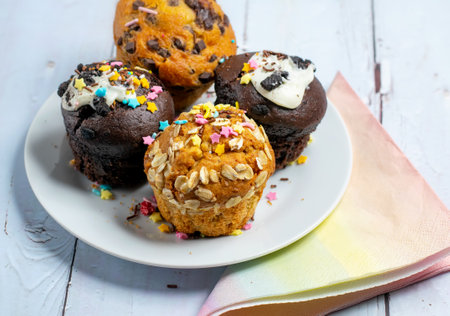 Variety of fresh muffins with colourful sprinklesの写真素材