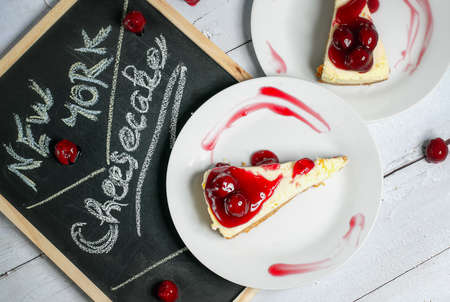 New York cheesecake with a cherry toppingの写真素材