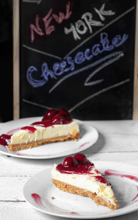 New York cheesecake with a cherry toppingの写真素材