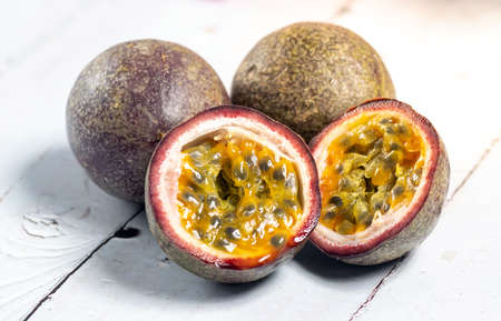 Halved passion fruit with orange seeds. Closeup macro.の写真素材