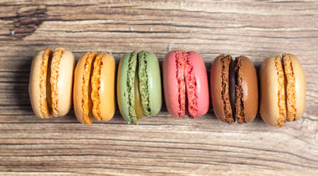 Colourful macaroon cakes on a wooden backgroundの写真素材