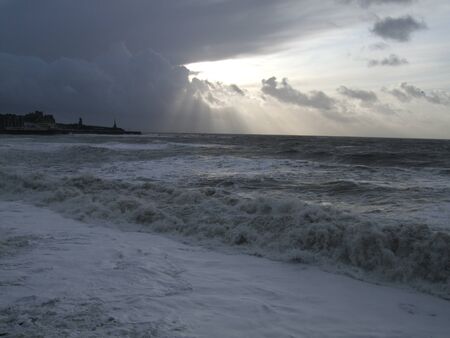 Big waves crashing against the beach.  Aberystwyth, Wales, UKの写真素材