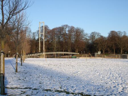 Snow covered park in Cardiff, UK with bridge over the River Taffの写真素材