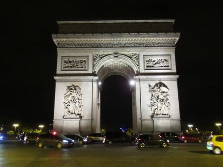 Arc de Triumphe at night illuminated with traffic. Paris, Franceの写真素材