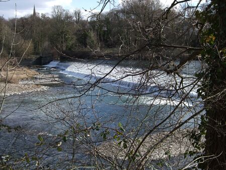 Weir across the River Taff near Radyr, Wales, UKの写真素材