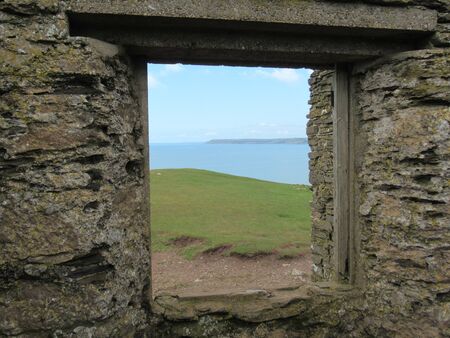 View through window of derelict house on Burgh Island, Devon UKの写真素材