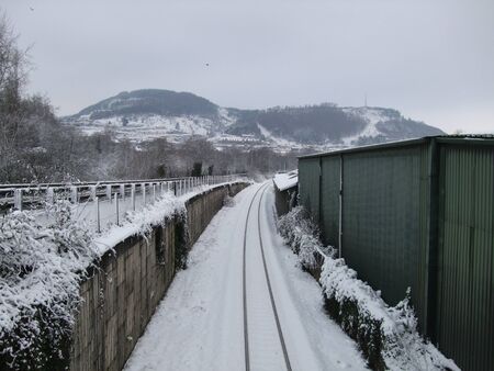 Single track railway line in the snow, Wales, UKの写真素材