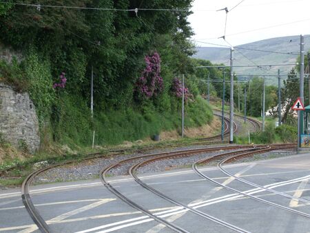 Tram lines crossing a main road in Laxey, Isle of Manの写真素材