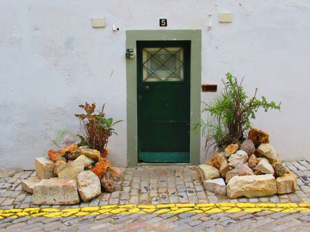 Old small front door on an old building in Portugalの写真素材