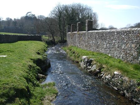 Stream by the wall of St David's Cathedral, Walesの写真素材