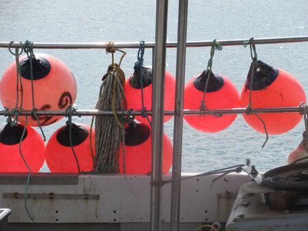 Fishing buoys on the side of a boat. Weymoth. Dorset, UKの写真素材
