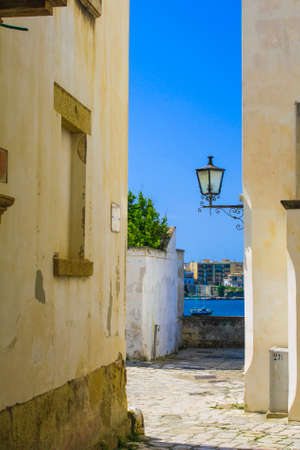 Narrow street of Otranto, sea viewの写真素材