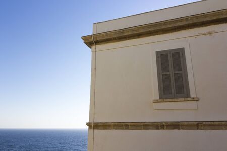 Window of a lighthouse on the seaの写真素材