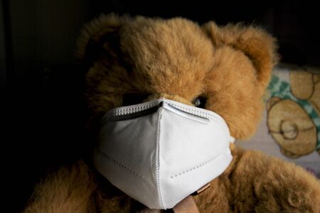 Coronavirus child: teddy bear with mask, quarantineの写真素材