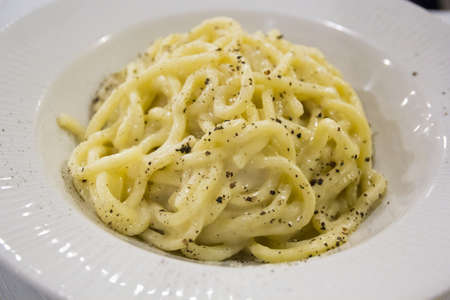 Spaghetti with cheese (cacio) and pepper, traditional Roman dish. Italian cuisineの写真素材