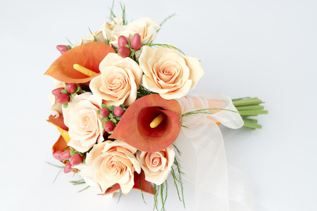 Colorful bouquet of orange calla lilies on a white backgroundの写真素材
