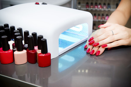 Manicure set in a beauty salon. Beautiful female hands.