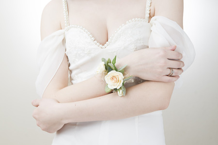 Bracelet of flowers on hand. Wedding accessories. Bride in white dressの写真素材