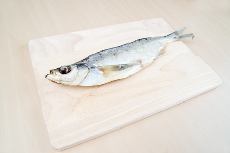 Dried saber fish on a cutting boardの写真素材