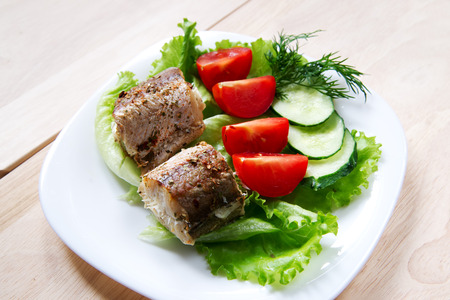 Fried fish with salad on plateの写真素材