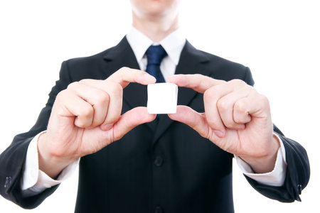 Business man with a cube in the hands isolated on white background.