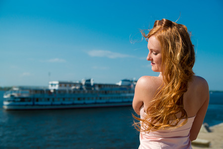 Beautiful young girl resting on river.の写真素材