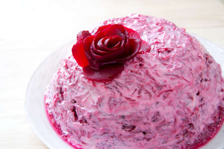 Garnish of beets with fish on white plate.の写真素材