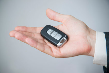 Businessman using car key. Keyless in male hand