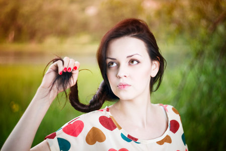 Portrait of a beautiful young woman in summer. Girl face closeup. Sunbeams.の写真素材