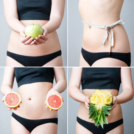 Overweight of the women with  fruit. Young female body on gray background. Weight loss, dietの写真素材