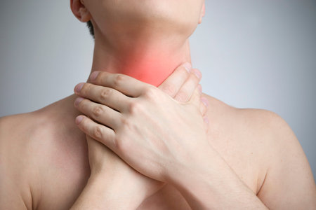 Sore throat of a men. Touching the neck. Red dot.