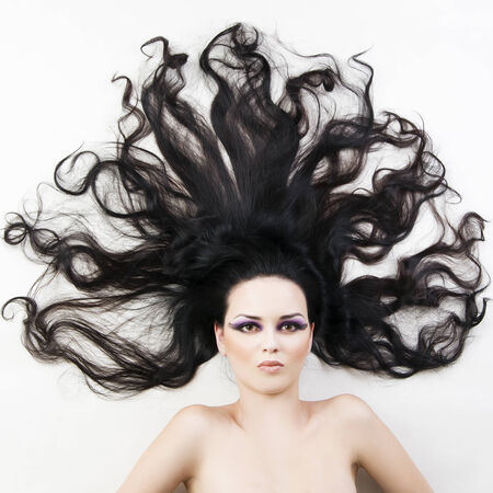 Portrait of a beautiful young woman on a white background. Professional make-up and hairstyle.の写真素材