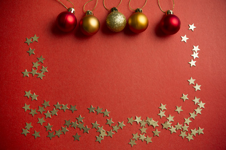 Christmas balls and stars to decorate on a red background. New year.の写真素材
