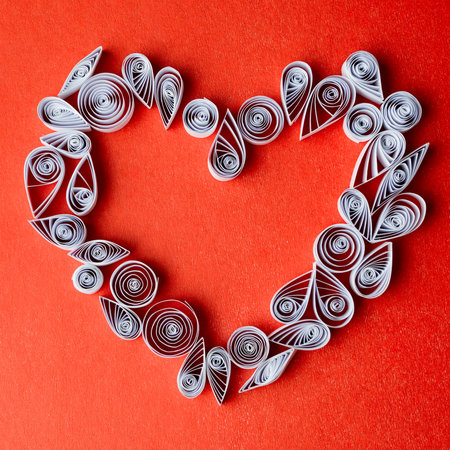 Quilling paper on red cardboard. Background with hearts for Valentine's day.の写真素材