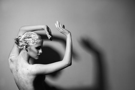 Portrait of the beautiful naked woman. Black and white photography. Body care. Spa. Mask of clayの写真素材