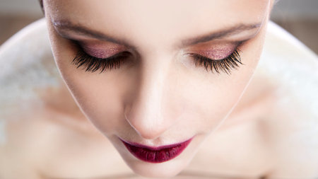Professional makeup. Clean skin. Part face. Portrait beautiful girl