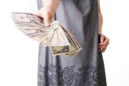 Woman with money in studio on a white backgroundの写真素材