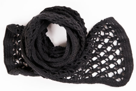Black lacy scarf crocheted wool on a white background.
