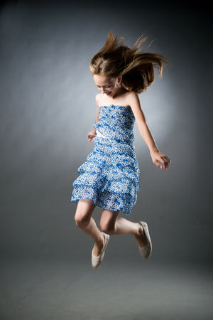 Portrait of a beautiful girl on a gray background in studio.の写真素材