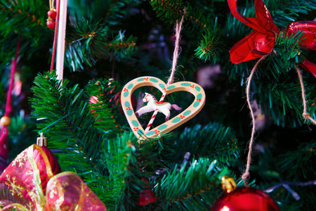 Christmas decorations hanging on pine branchesの写真素材