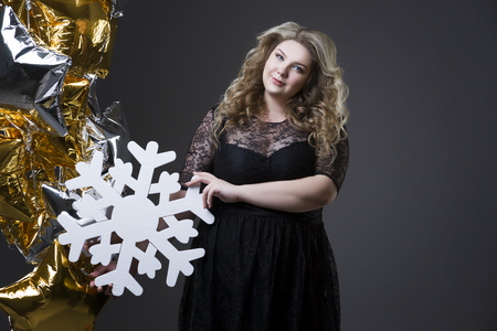 Plus size woman with snowflake and balloonsの写真素材
