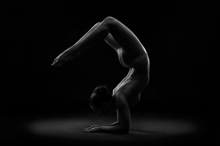 Art nude, perfect naked body, sexy young woman on dark background, black and white photography,...