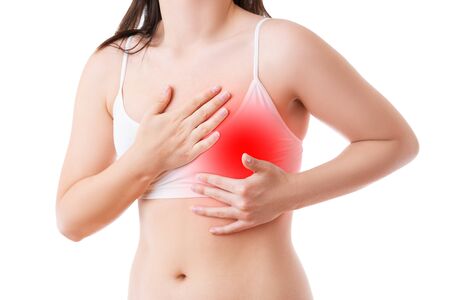 Heart attack, woman with chest pain isolated on white background, cardiovascular disease concept, painful area highlighted in redの写真素材