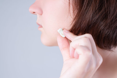 Wisdom tooth extraction, woman suffering from a toothache on gray background, dentistry concept