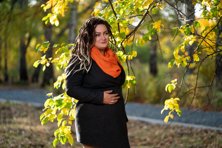 Woman with dreadlocks outdoors in autumn, youth culture concept
