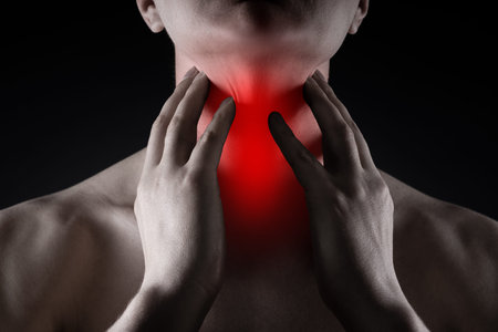 Sore throat, men with pain in neck on black background, painful area highlighted in red