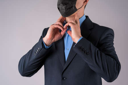 Office worker with symptoms on gray background, studio shotの写真素材